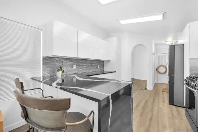 a kitchen with a table chairs sink and stove