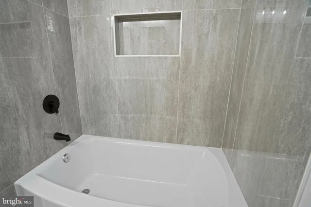 a bathroom with a white bath tub