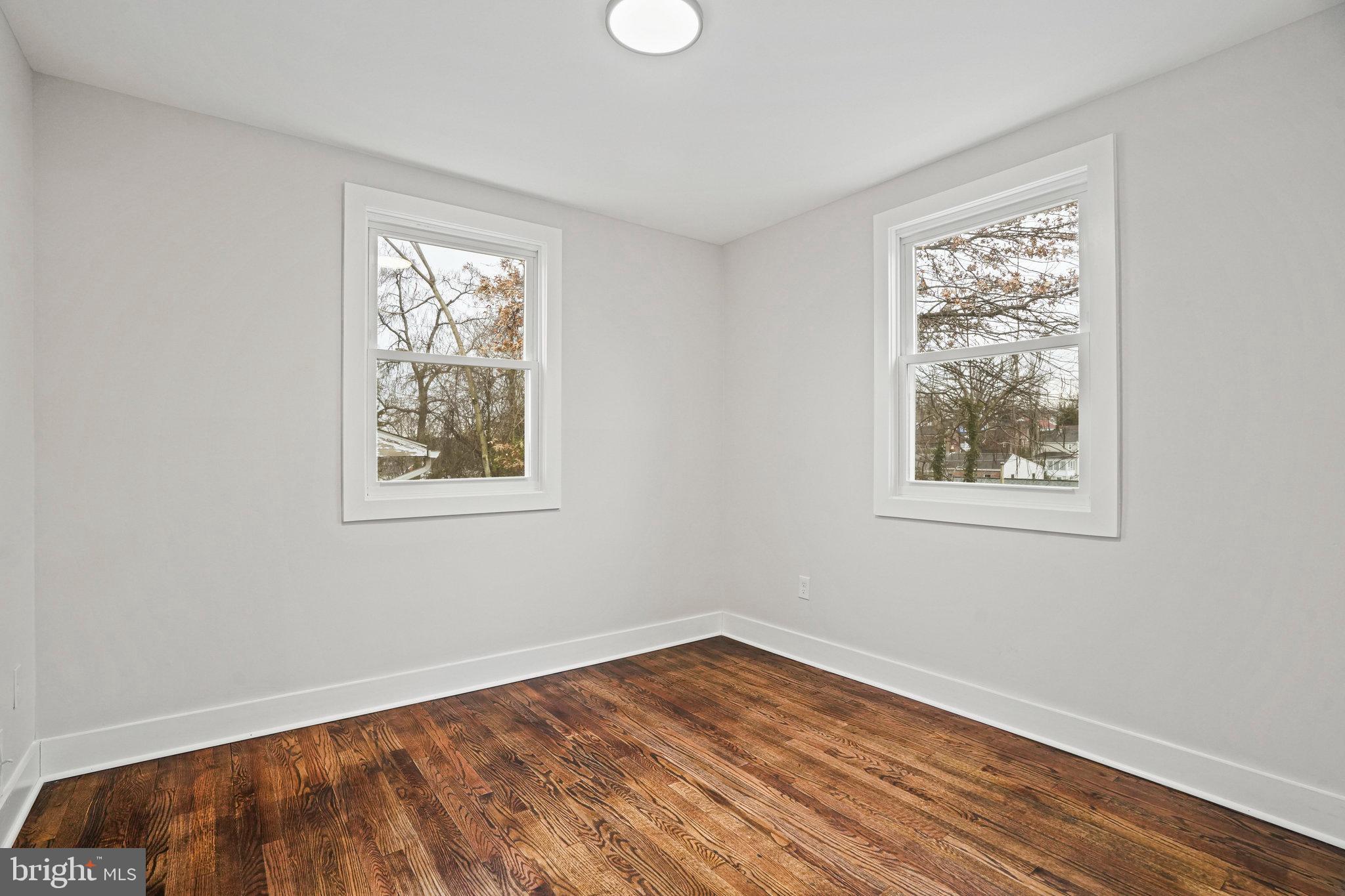 4201 Torque Street Capitol Heights, MD 20743 - Photo 16 of 38 a view of an empty room with wooden floor and a window