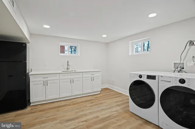 a view of a kitchen with sink washer and dryer