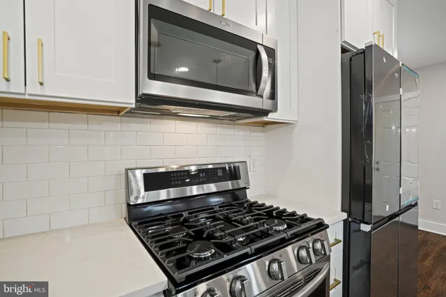 a stove top oven sitting inside of a kitchen