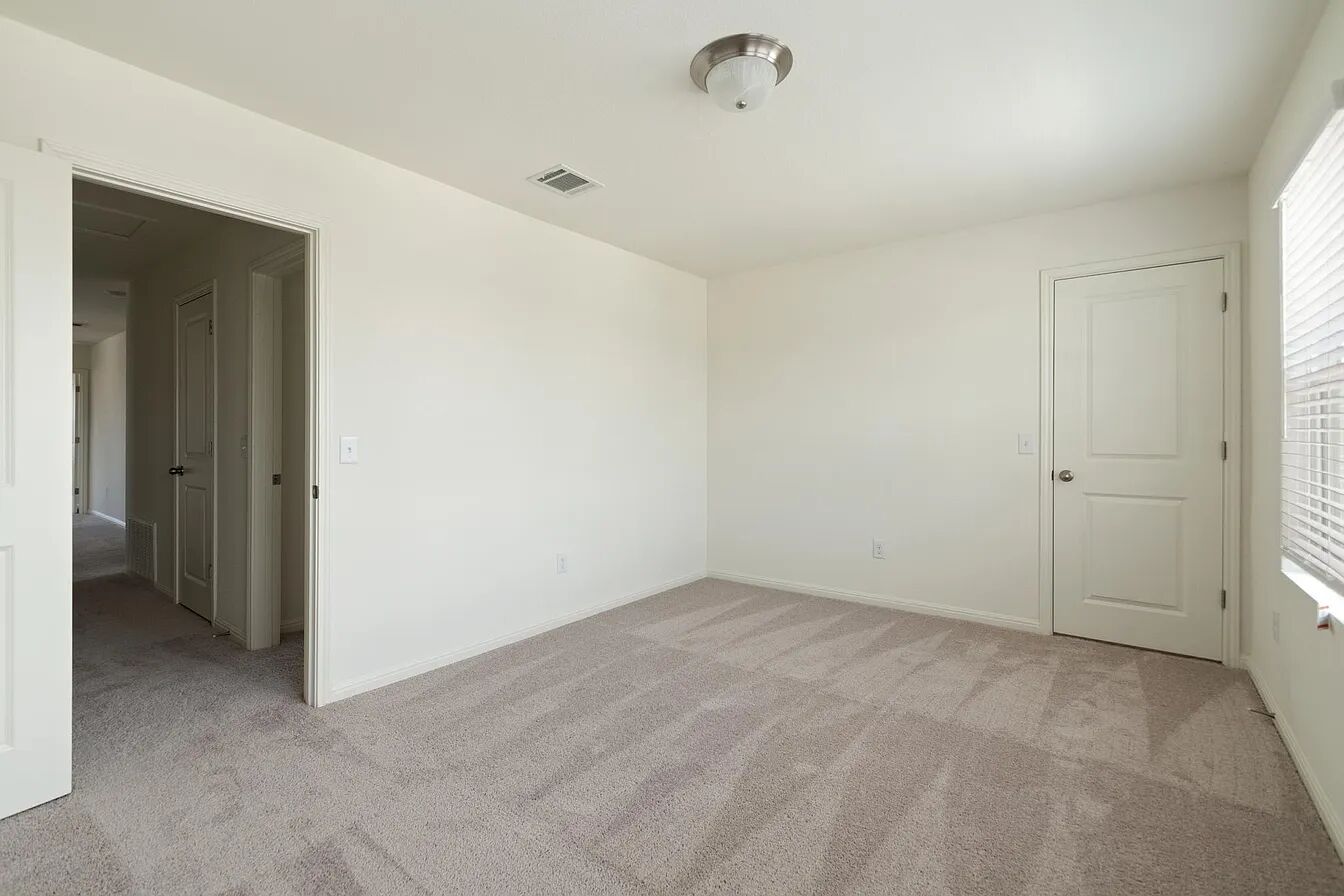 101 Aoudad Road Hutto, TX 78634 - Photo 19 of 39 A quiet retreat, this bedroom offers fresh carpeting and ample light.