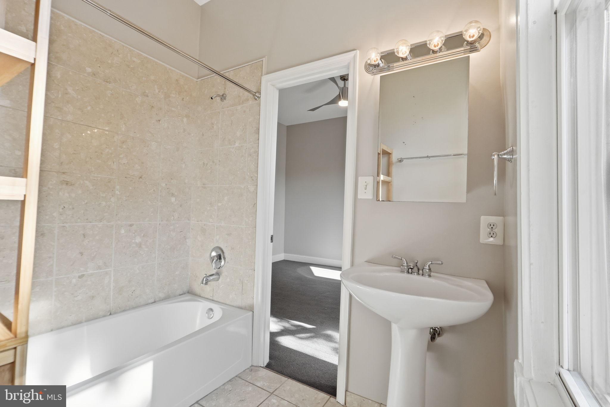 706 12th Street Northeast Washington, DC 20002 - Photo 18 of 49 a bathroom with a sink a toilet and shower