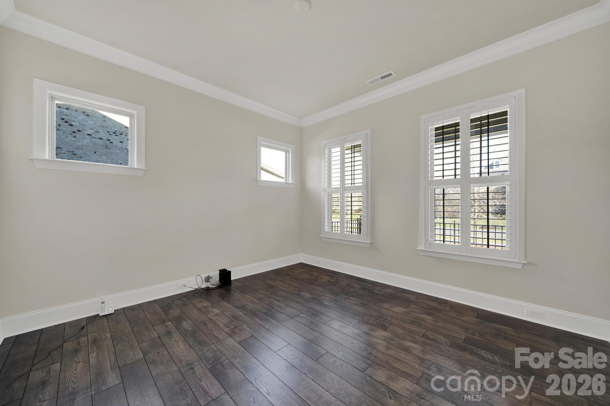 6507 Calvert Commons Drive Huntersville, NC 28078 - Photo 12 of 47 a view of empty room with wooden floor and fan