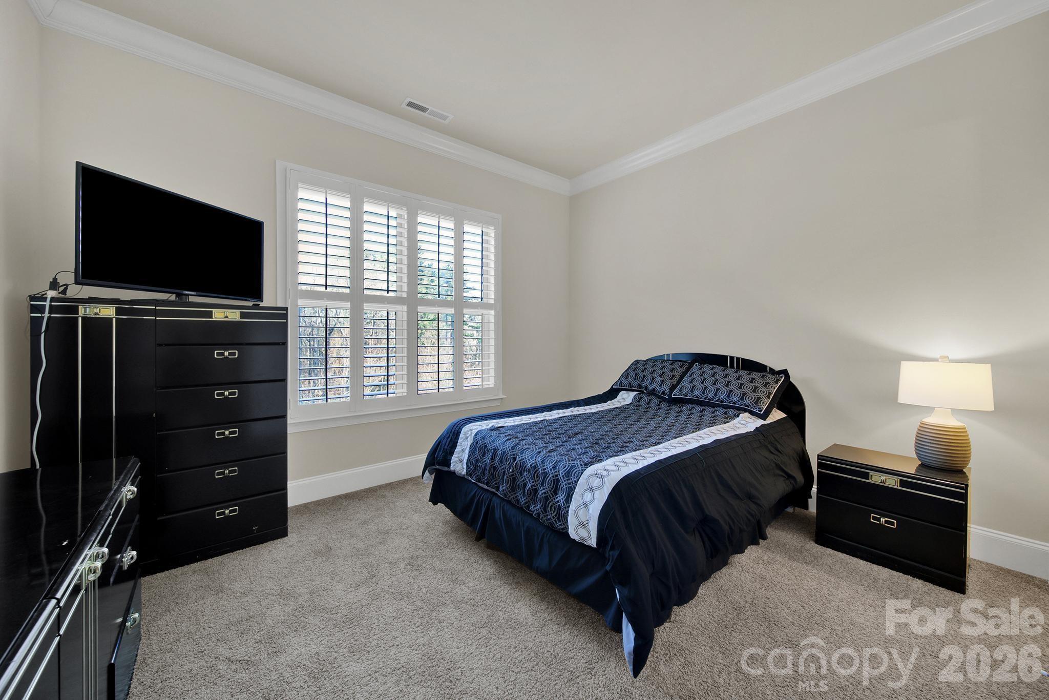 6507 Calvert Commons Drive Huntersville, NC 28078 - Photo 15 of 47 a bedroom with a bed and a television