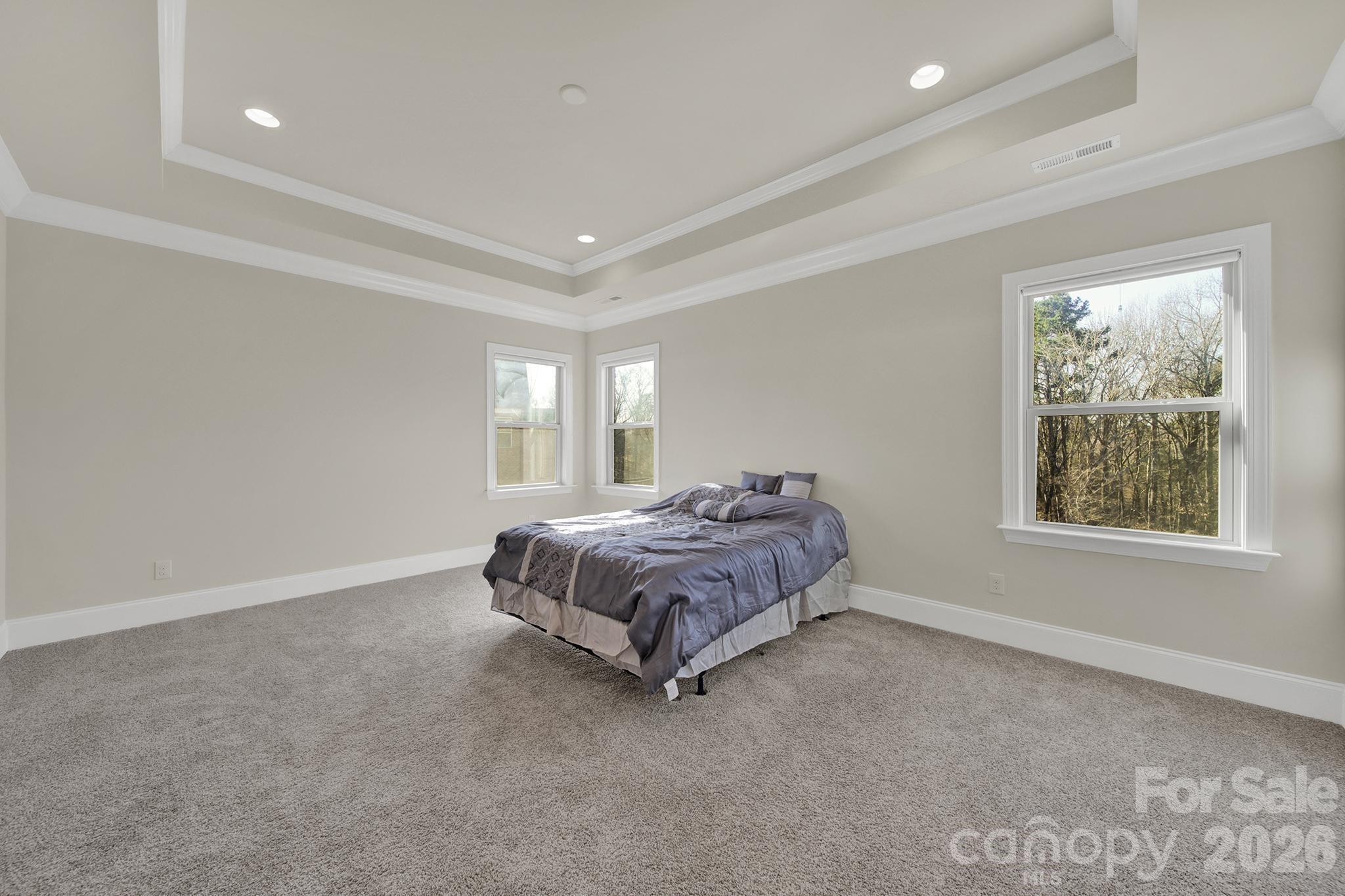 6507 Calvert Commons Drive Huntersville, NC 28078 - Photo 18 of 47 a bed sitting in a spacious bedroom next to a window