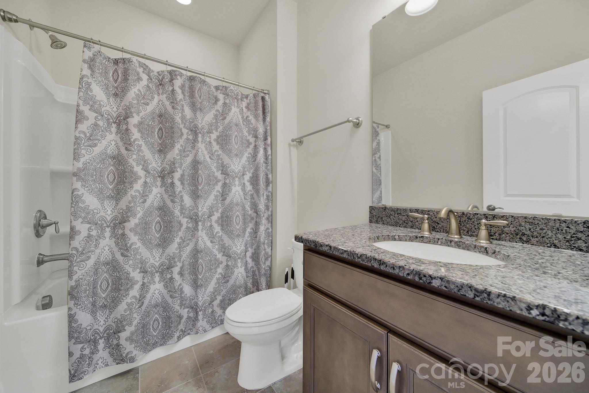 6507 Calvert Commons Drive Huntersville, NC 28078 - Photo 24 of 47 a bathroom with a granite countertop sink and a mirror