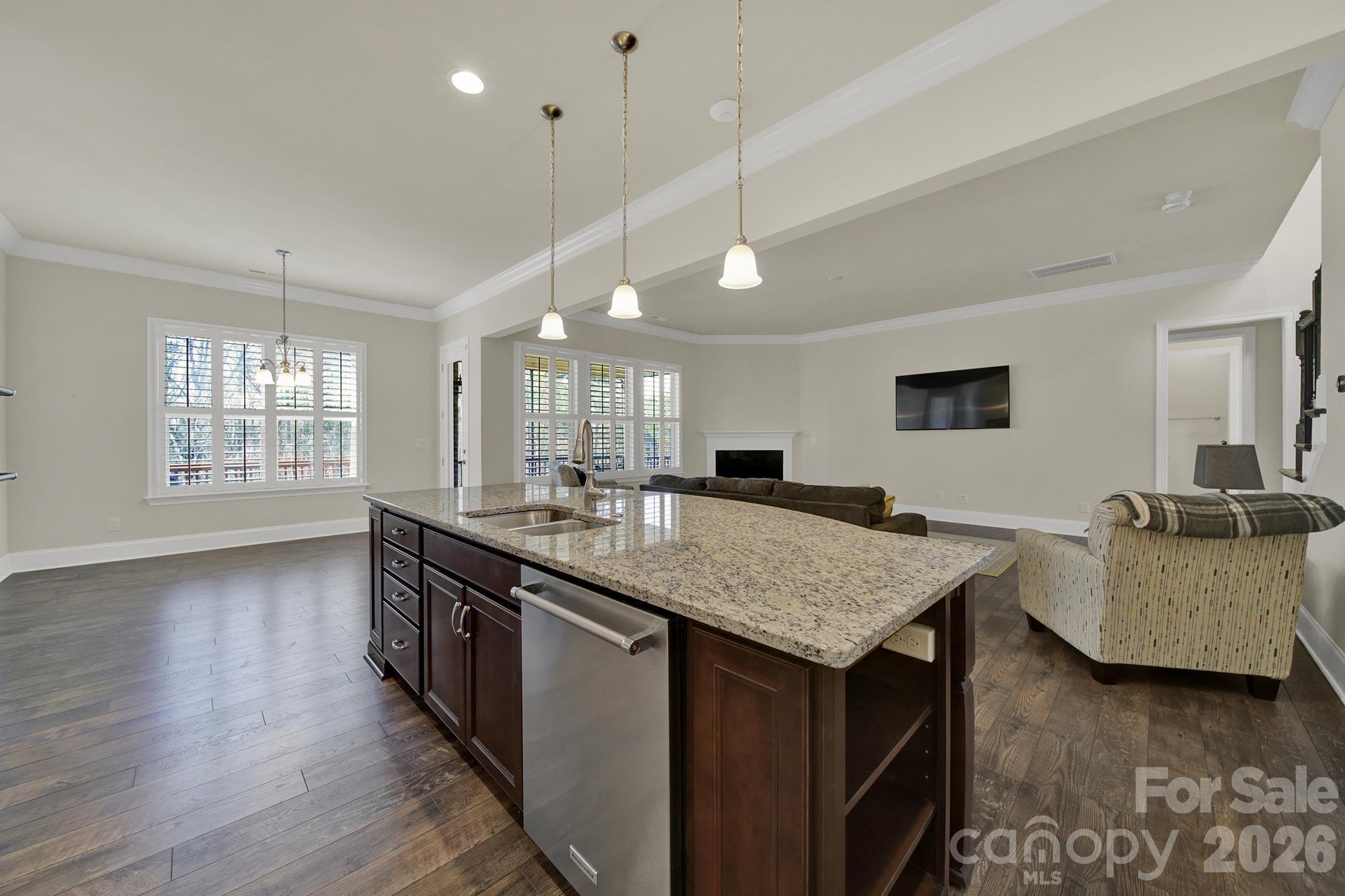 6507 Calvert Commons Drive Huntersville, NC 28078 - Photo 7 of 47 a kitchen with granite countertop a table and chairs in it