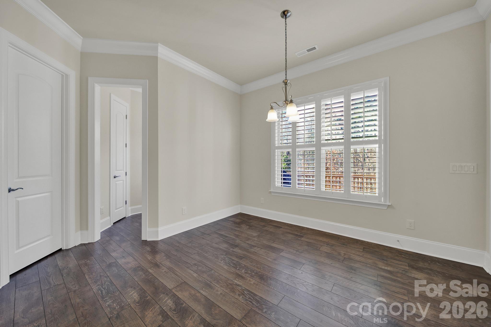 6507 Calvert Commons Drive Huntersville, NC 28078 - Photo 8 of 47 a view of an empty room with wooden floor and a window