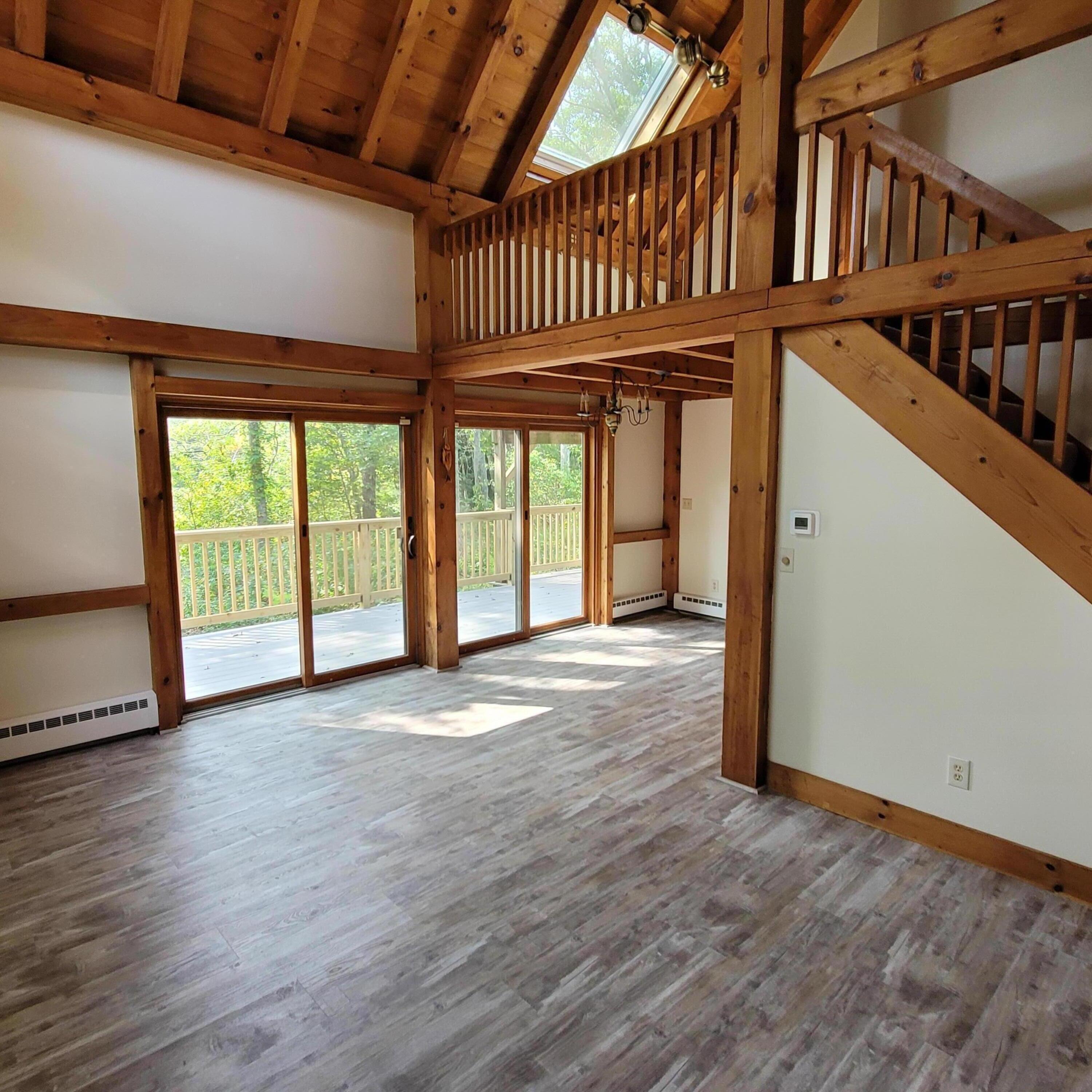73 Suomi Road Hyannis, MA 02601 - Photo 4 of 13 an empty room with wooden floor and windows