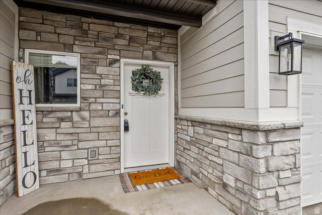 287 North 100th West Morgan, UT 84050 - Photo 4 of 27 View of exterior entry with stone siding and a garage