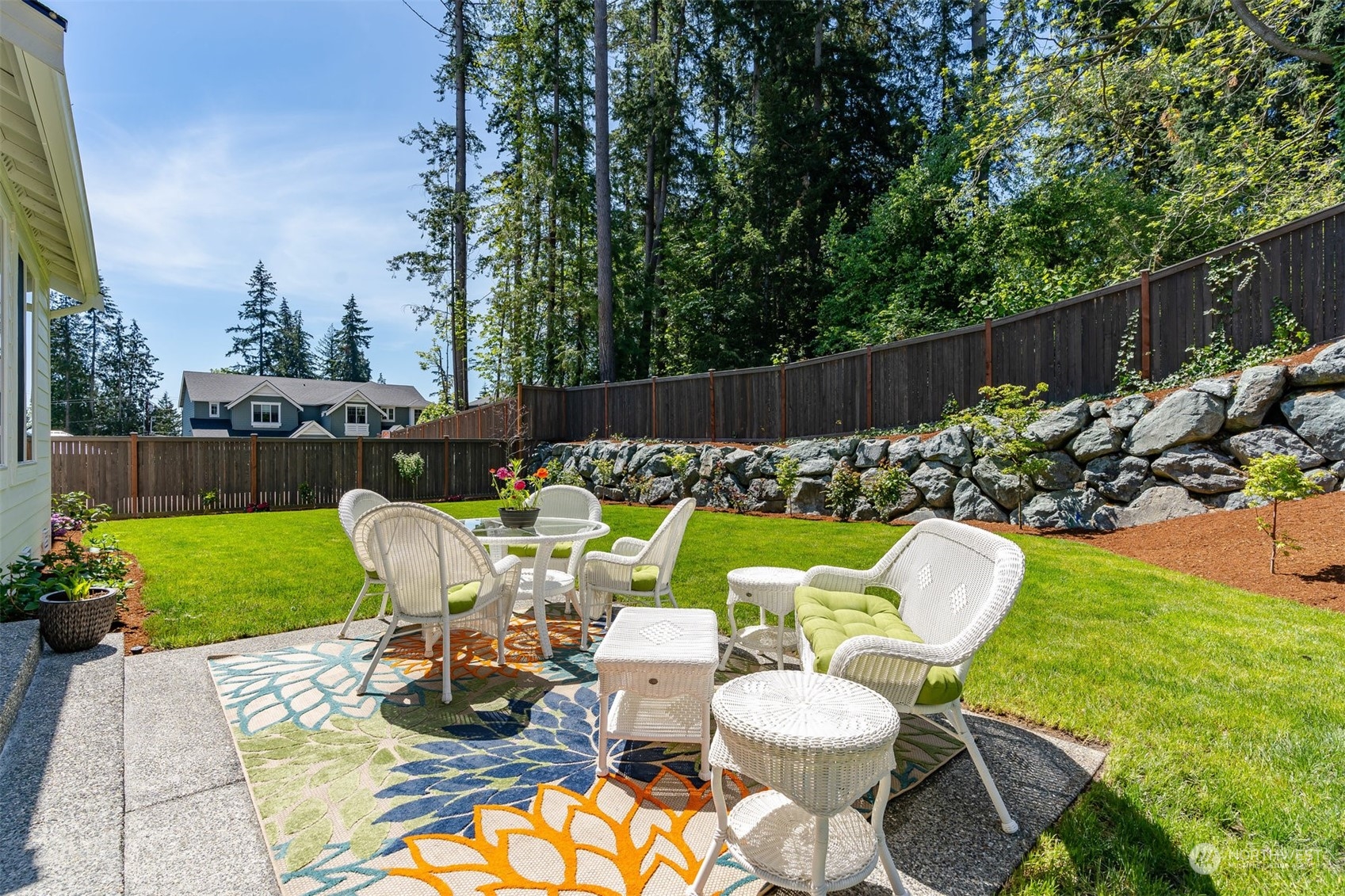 23902 1st Avenue Southeast Bothell, WA 98021 - Photo 30 of 39 a view of a chair and table in backyard with a fire pit and grass