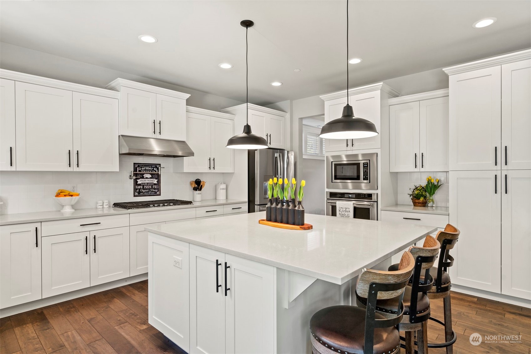 23902 1st Avenue Southeast Bothell, WA 98021 - Photo 10 of 39 a kitchen with stainless steel appliances kitchen island a table and chairs in it