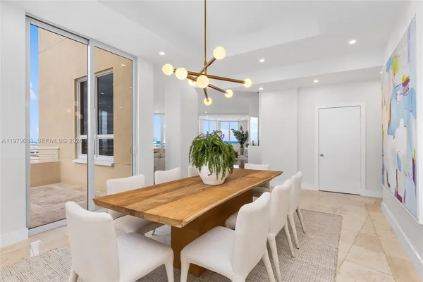 a kitchen with kitchen island granite countertop a sink and stainless steel appliances