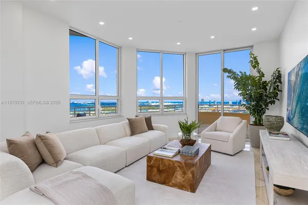 a living room with furniture and a large window