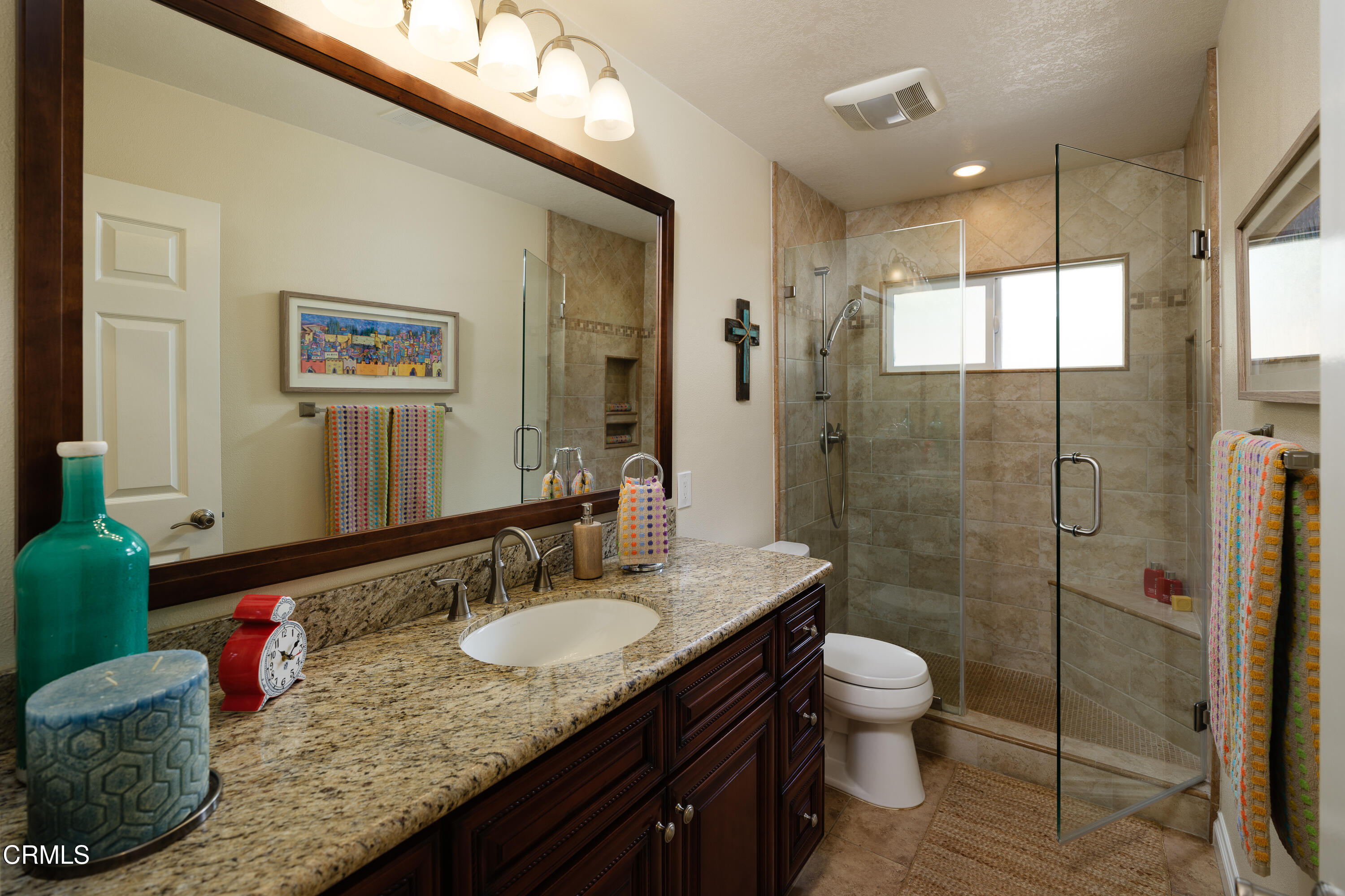 7271 Brydon Road La Verne, CA 91750 - Photo 23 of 63 a bathroom with a granite countertop sink a toilet a mirror and shower