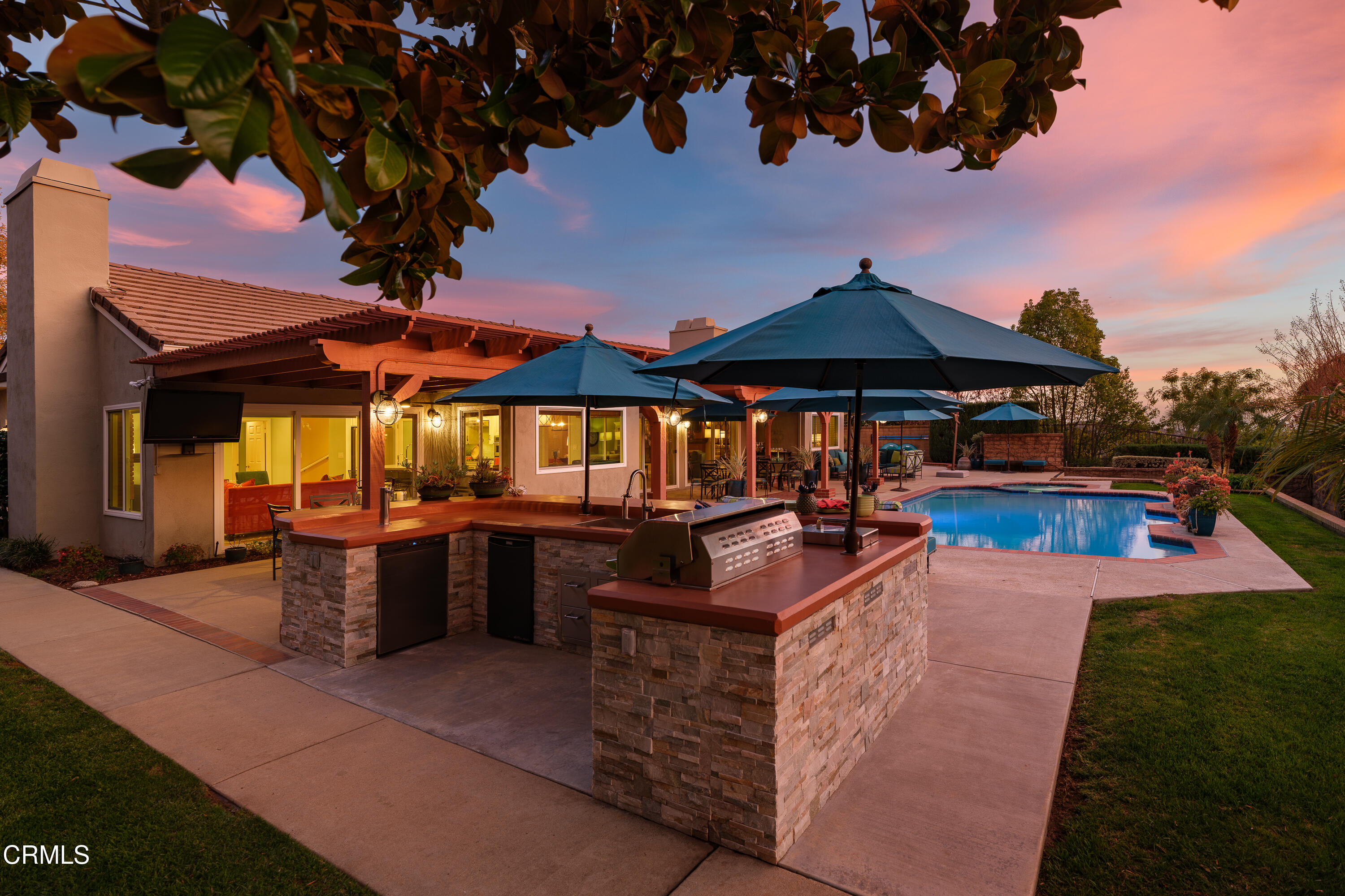 7271 Brydon Road La Verne, CA 91750 - Photo 37 of 63 a view of a patio with dining table and chairs under an umbrella with a fire pit