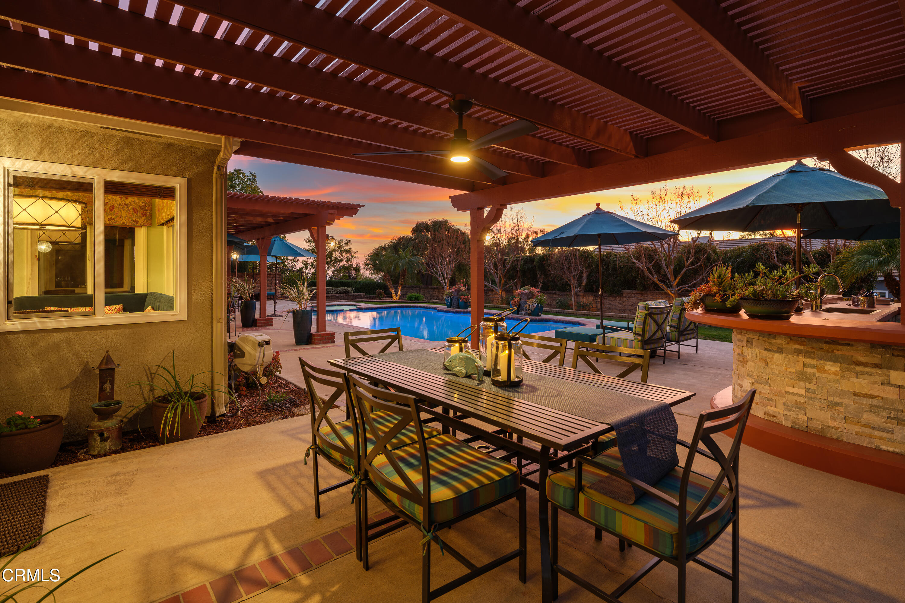 7271 Brydon Road La Verne, CA 91750 - Photo 38 of 63 a view of a patio with table and chairs under an umbrella with a barbeque