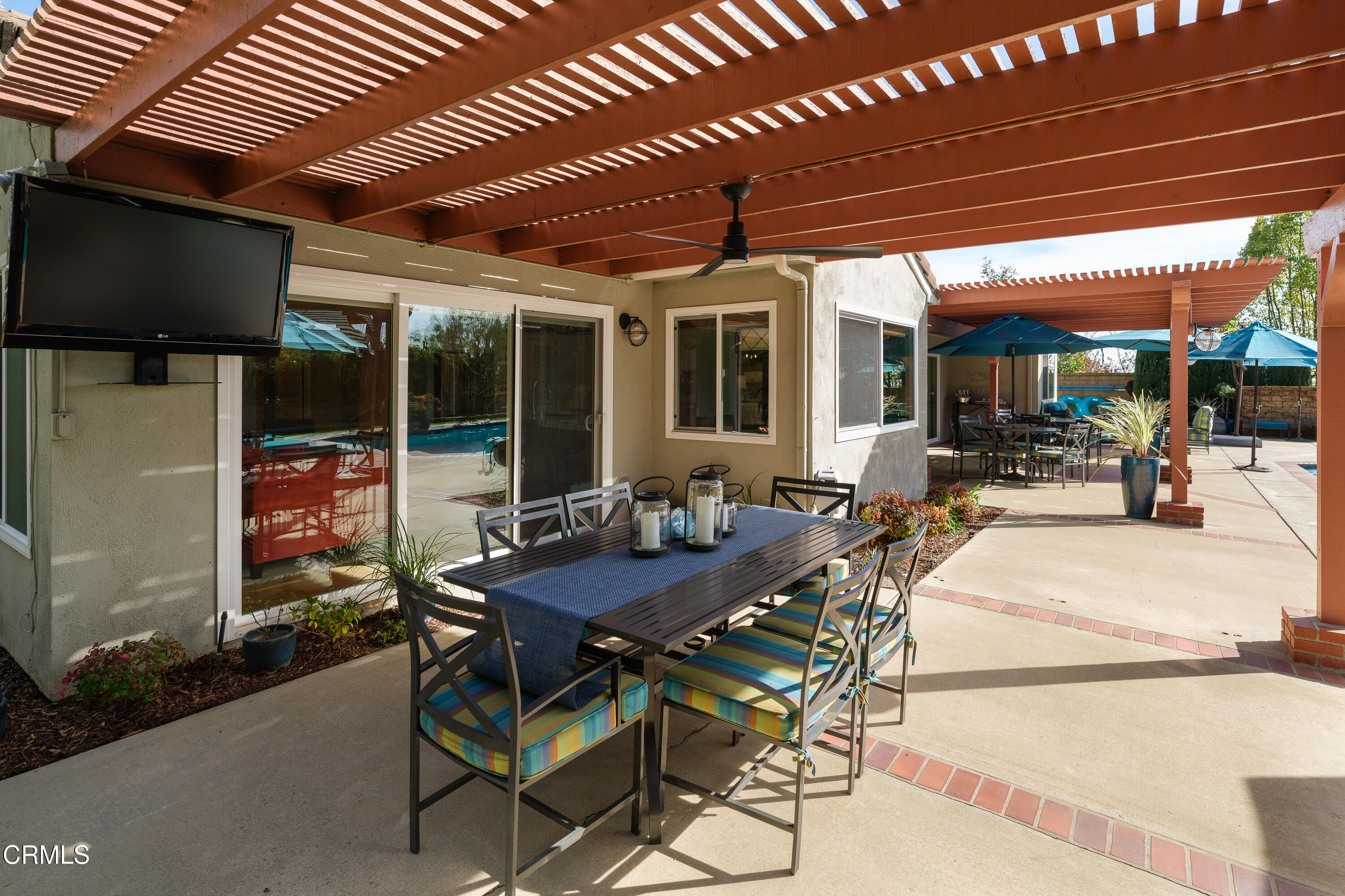 7271 Brydon Road La Verne, CA 91750 - Photo 55 of 63 a view of a patio with table and chairs potted plants and floor to ceiling window