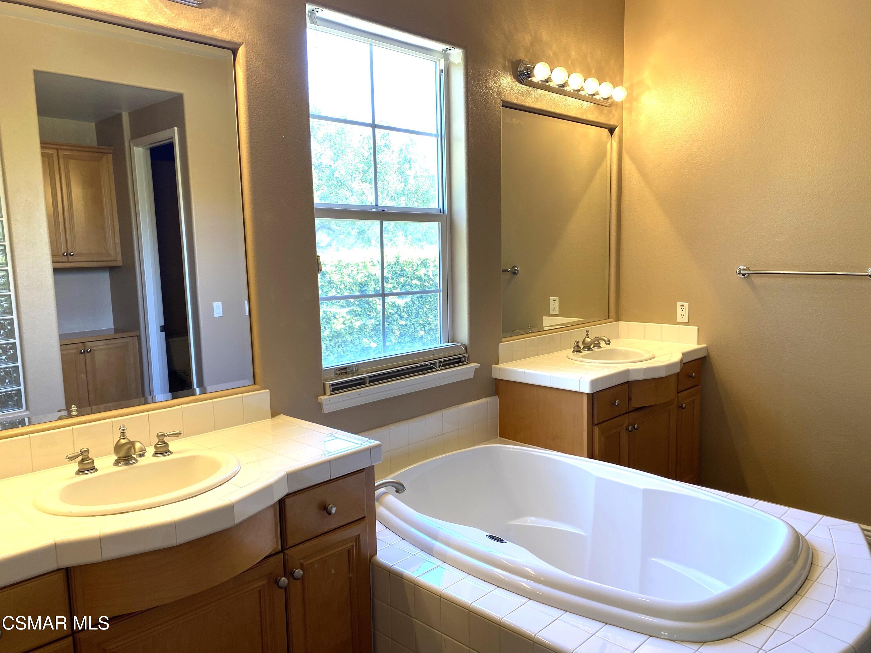 4501 Via Rio Newbury Park, CA 91320 - Photo 18 of 24 a bathroom with a tub sink and mirror