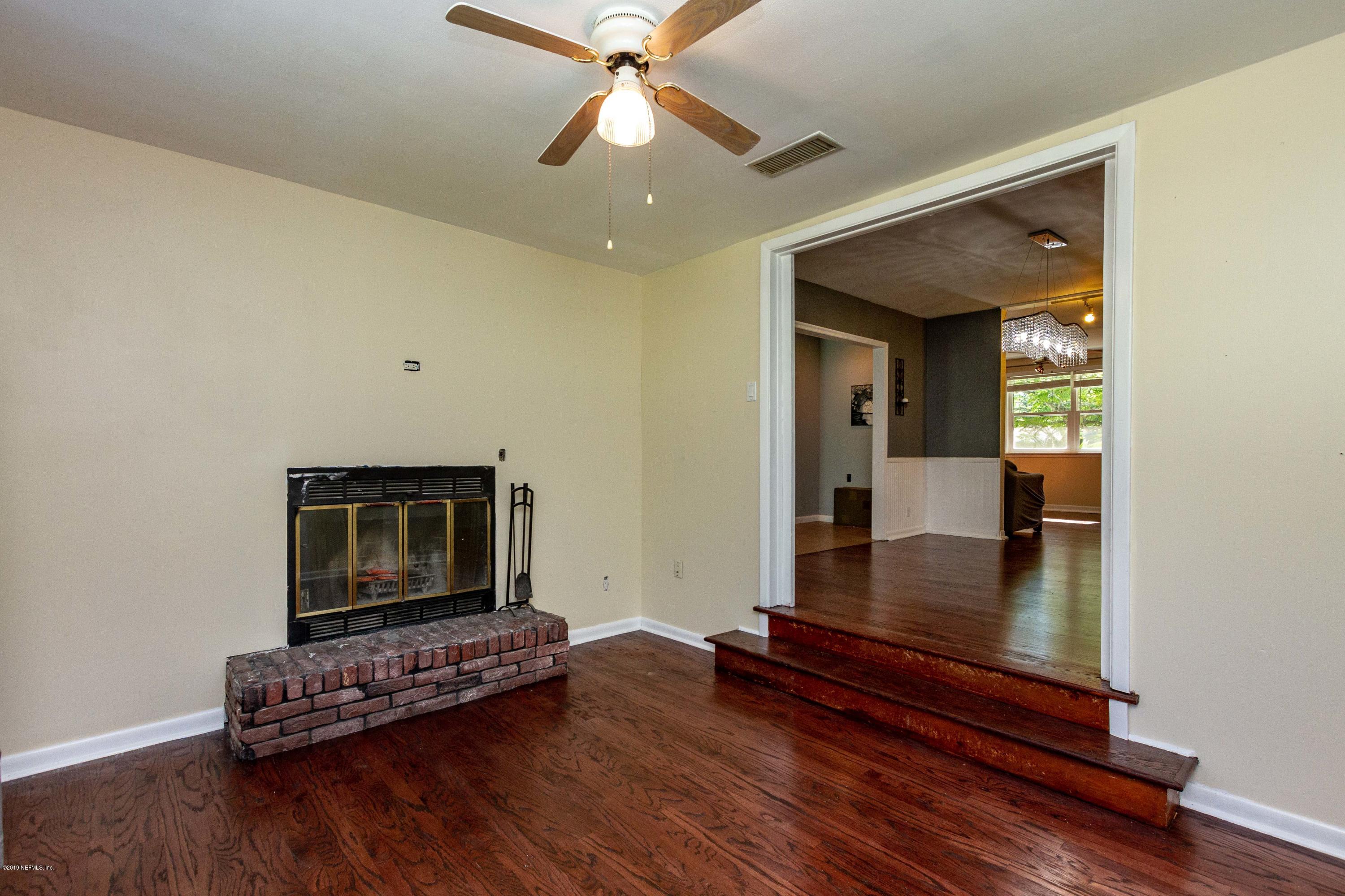 7420 Hennessy Road Jacksonville, FL 32244 - Photo 12 of 39 a living room with furniture and a wooden floor