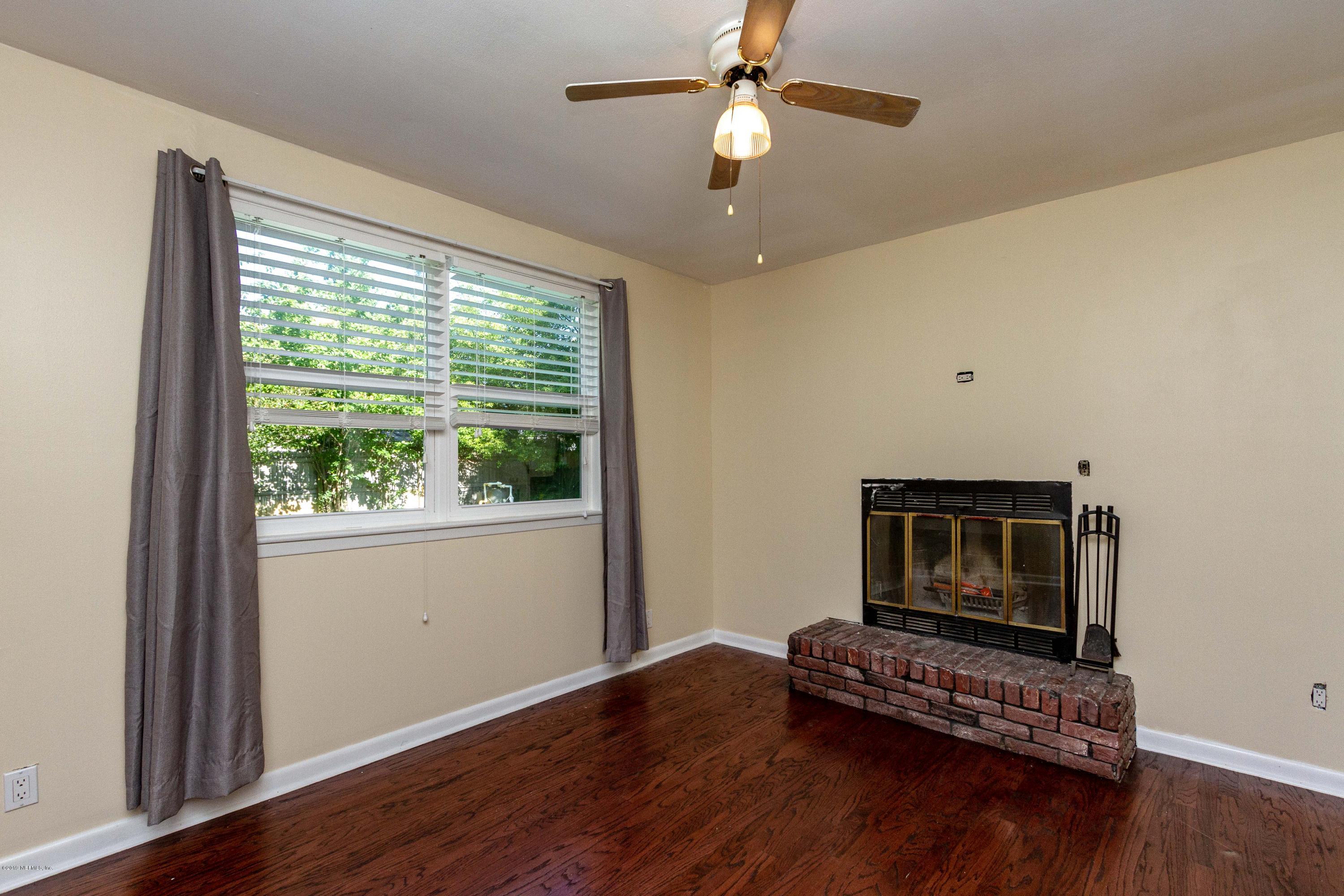 7420 Hennessy Road Jacksonville, FL 32244 - Photo 13 of 39 a view of an empty room with wooden floor and a window
