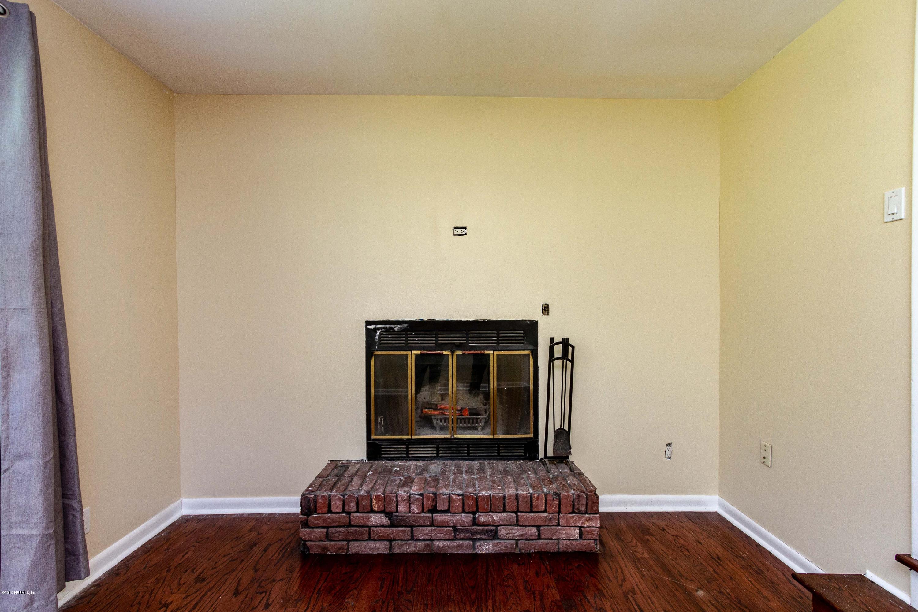 7420 Hennessy Road Jacksonville, FL 32244 - Photo 14 of 39 a living room with furniture and wooden floor