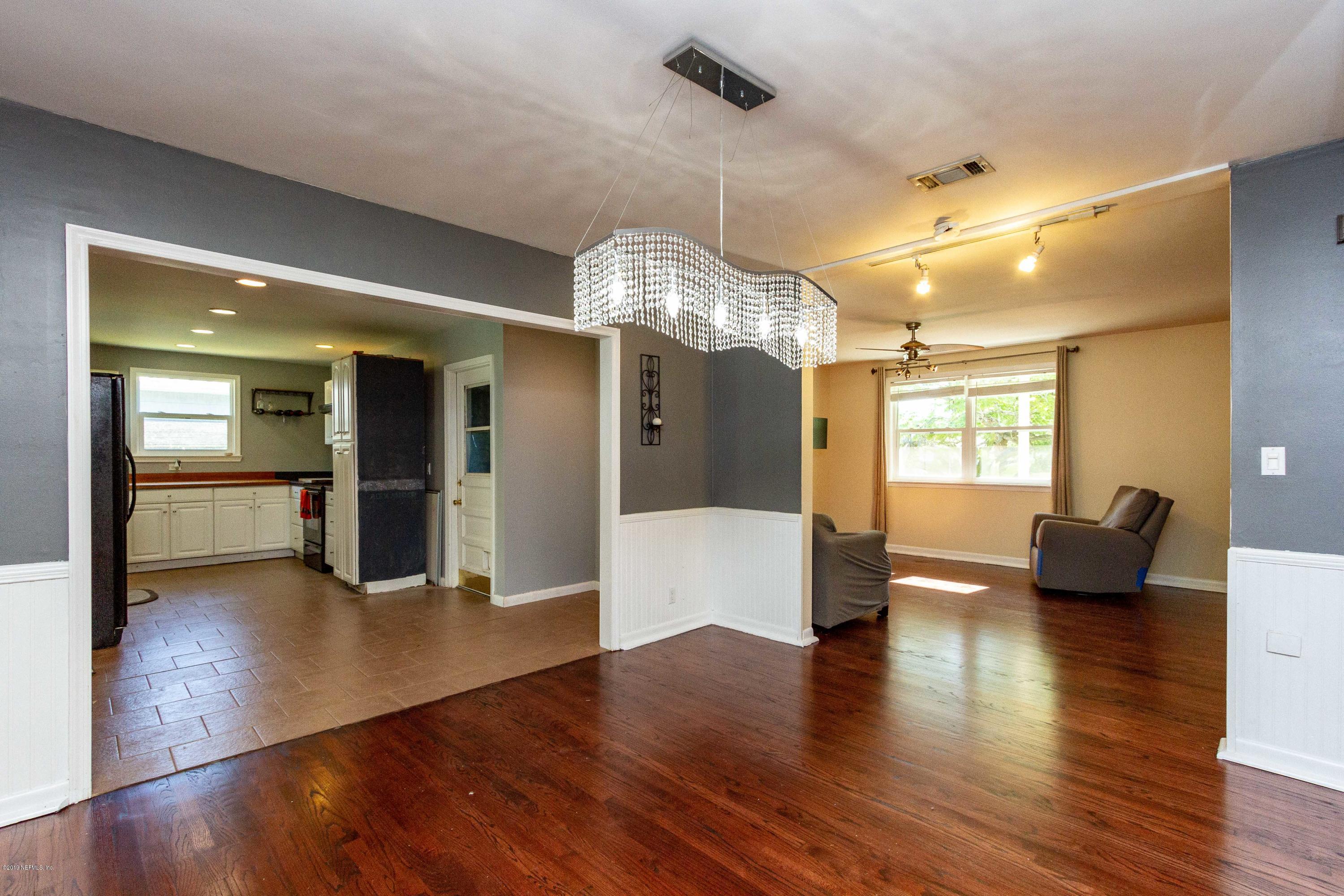 7420 Hennessy Road Jacksonville, FL 32244 - Photo 15 of 39 a view of a living room and kitchen with wooden floor