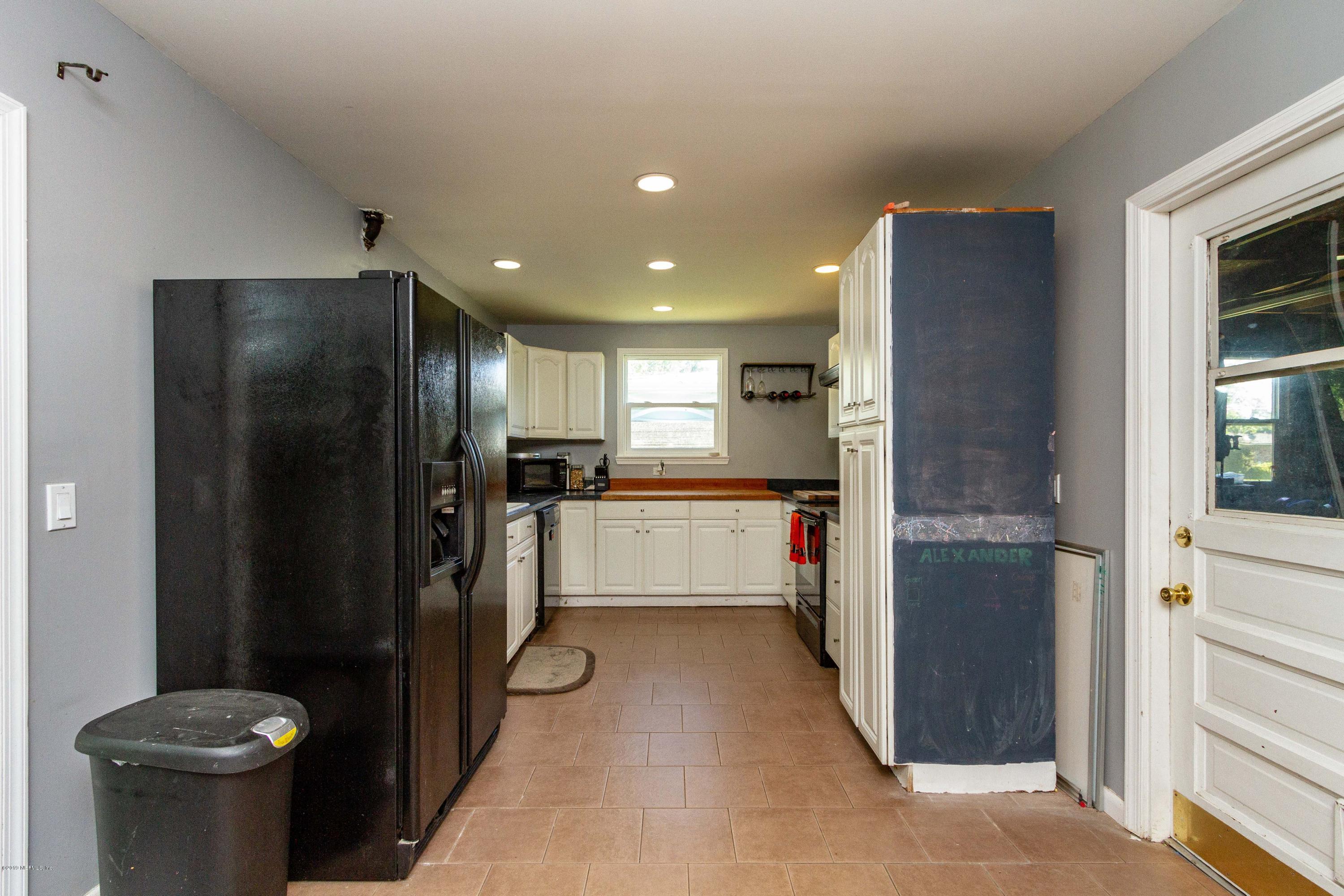 7420 Hennessy Road Jacksonville, FL 32244 - Photo 17 of 39 a kitchen with a refrigerator and a stove