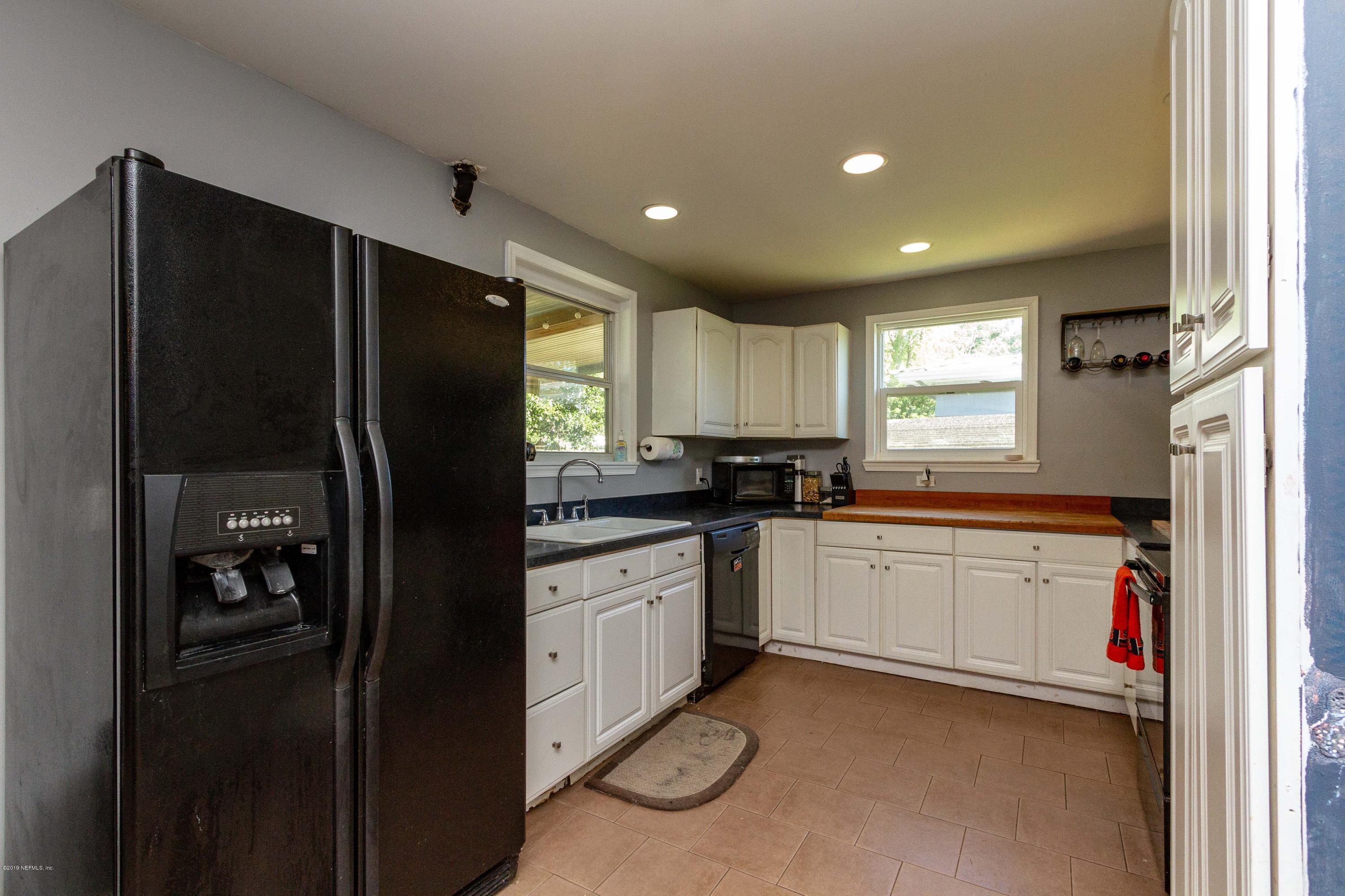 7420 Hennessy Road Jacksonville, FL 32244 - Photo 18 of 39 a kitchen with granite countertop stainless steel appliances a refrigerator a sink a stove a microwave and cabinets