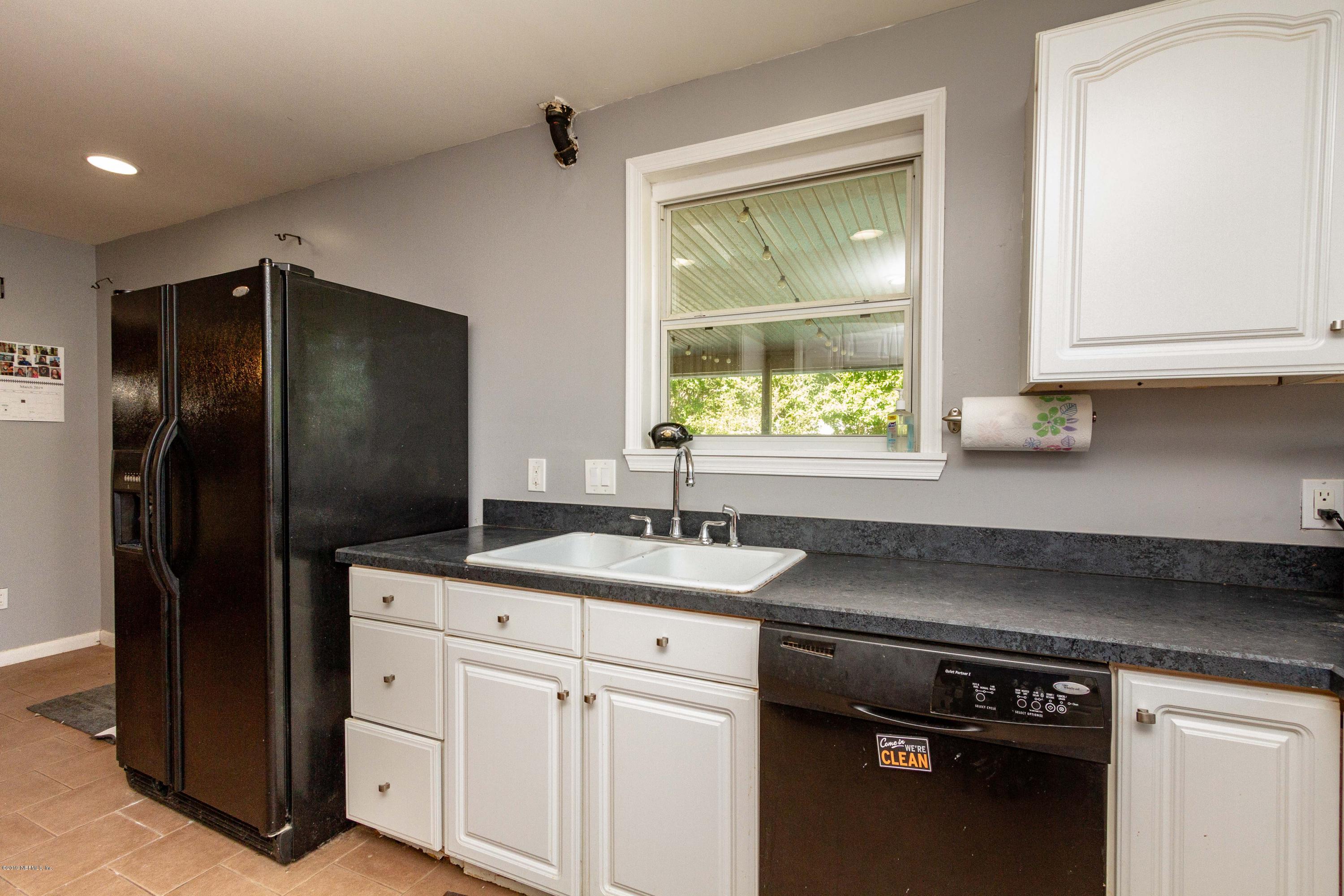 7420 Hennessy Road Jacksonville, FL 32244 - Photo 19 of 39 a kitchen with a refrigerator and a sink