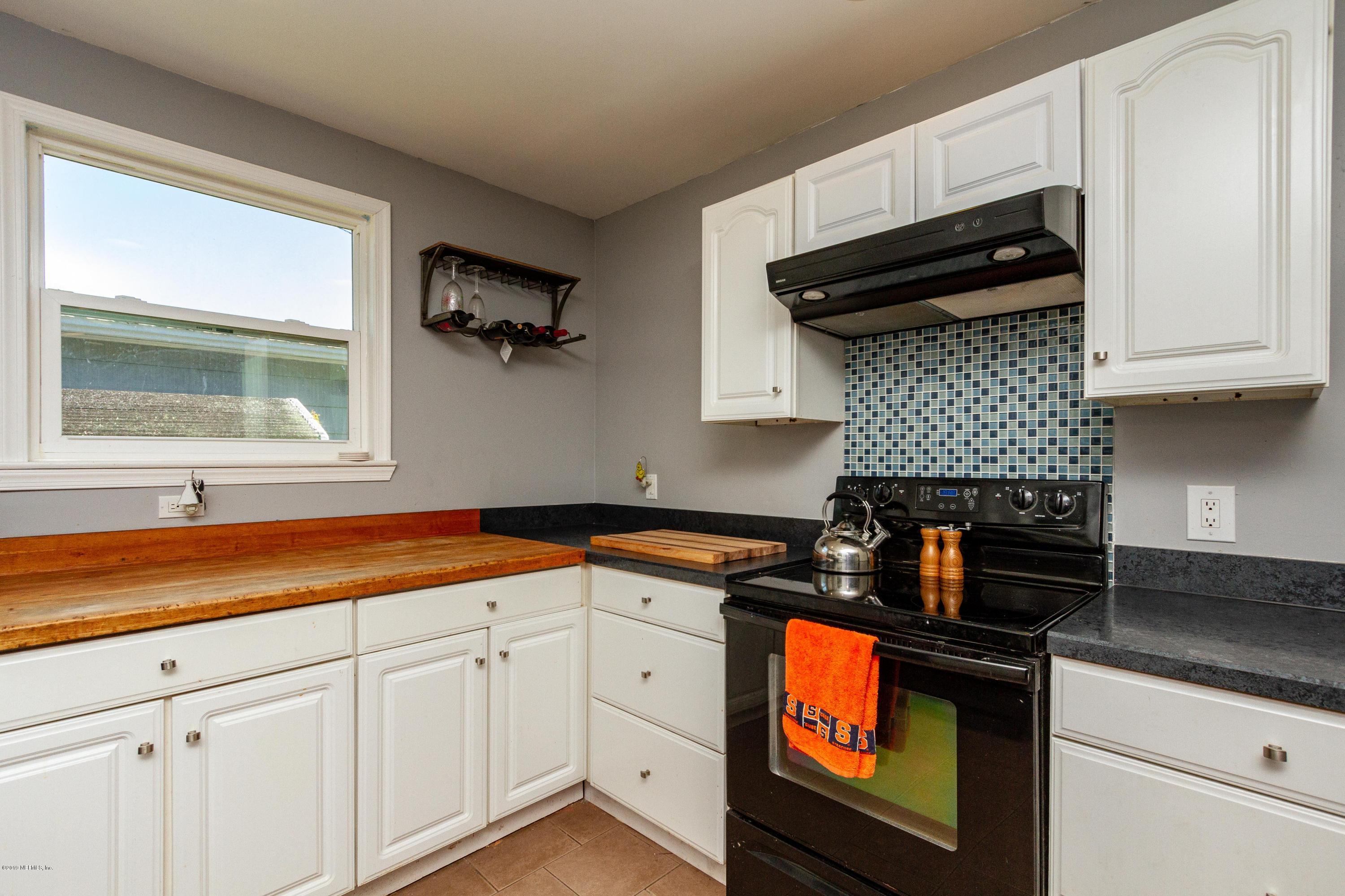 7420 Hennessy Road Jacksonville, FL 32244 - Photo 20 of 39 a kitchen with granite countertop a sink a stove and cabinets