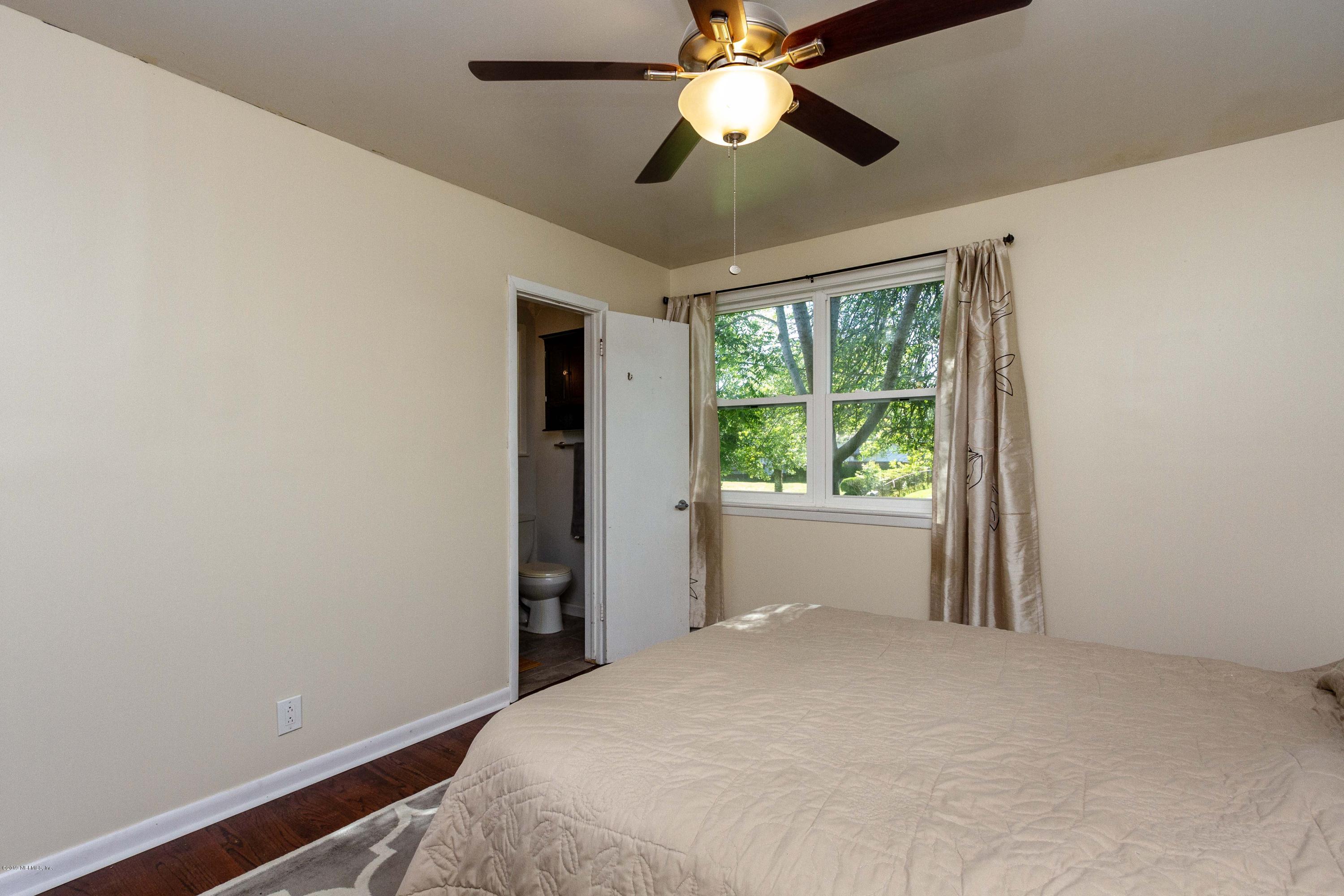 7420 Hennessy Road Jacksonville, FL 32244 - Photo 23 of 39 a bedroom with a large bed and a window