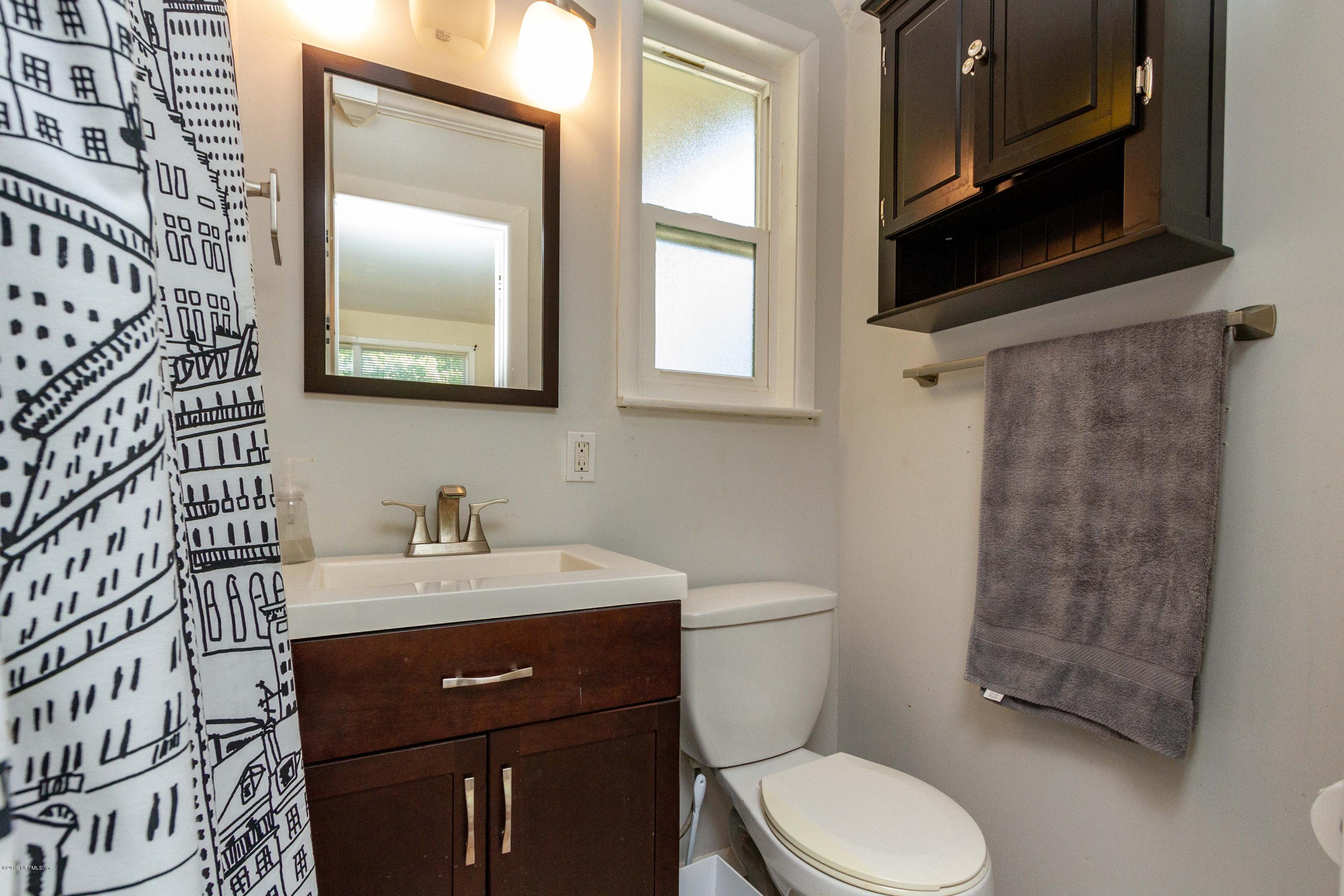 7420 Hennessy Road Jacksonville, FL 32244 - Photo 25 of 39 a bathroom with a toilet a sink and a mirror
