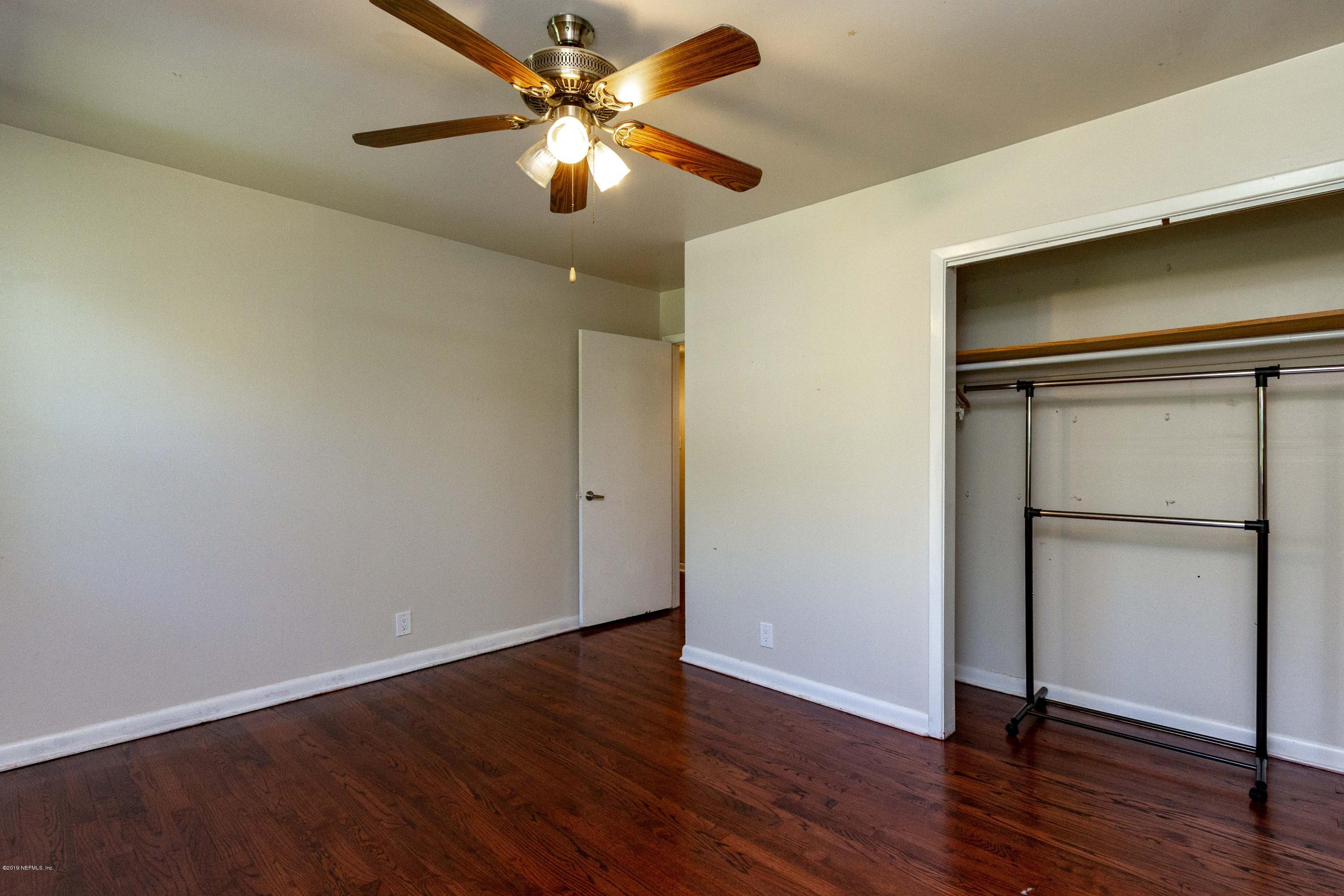 7420 Hennessy Road Jacksonville, FL 32244 - Photo 30 of 39 a view of an empty room with wooden floor