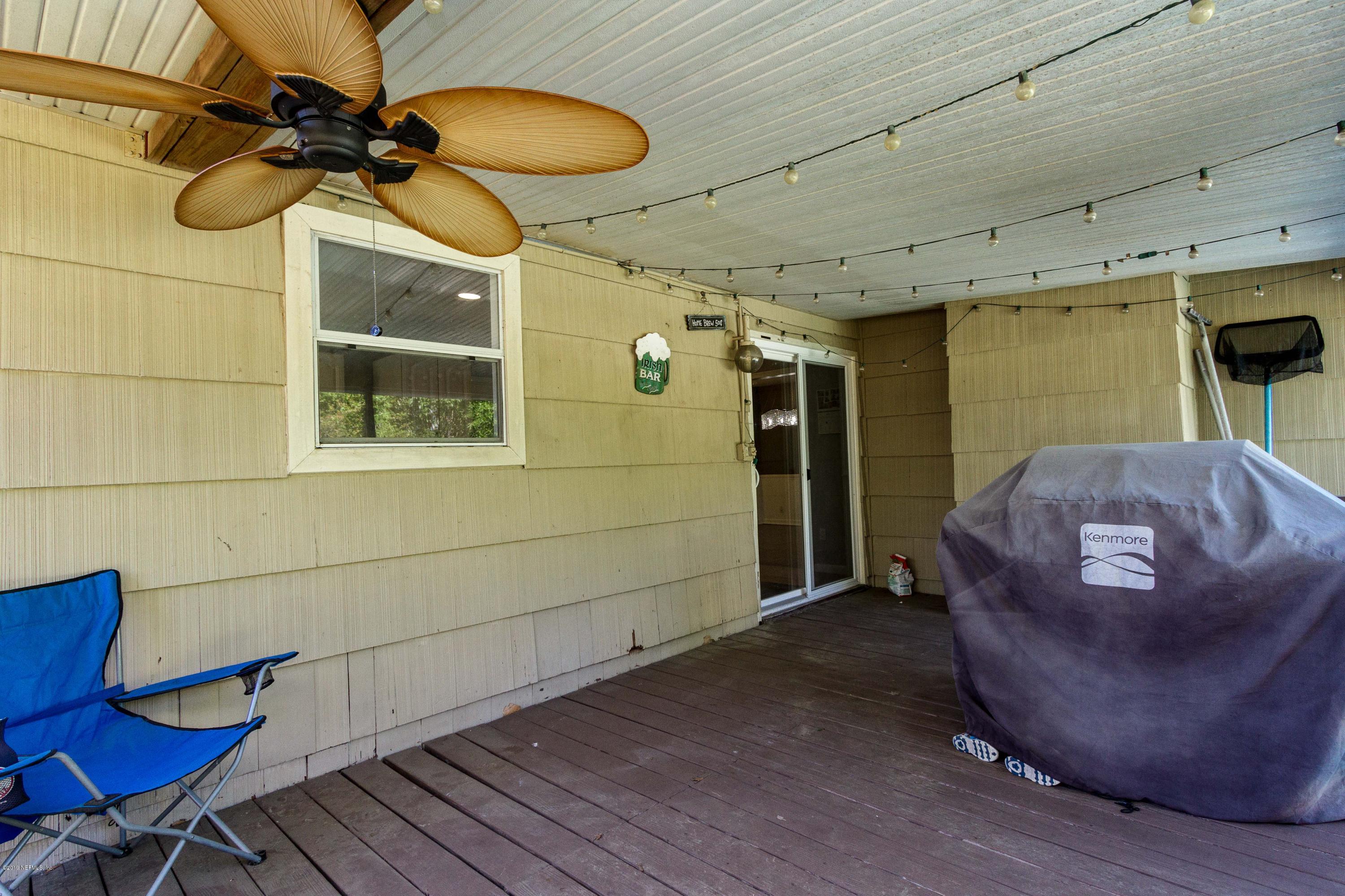 7420 Hennessy Road Jacksonville, FL 32244 - Photo 31 of 39 a view of a porch with furniture and a yard