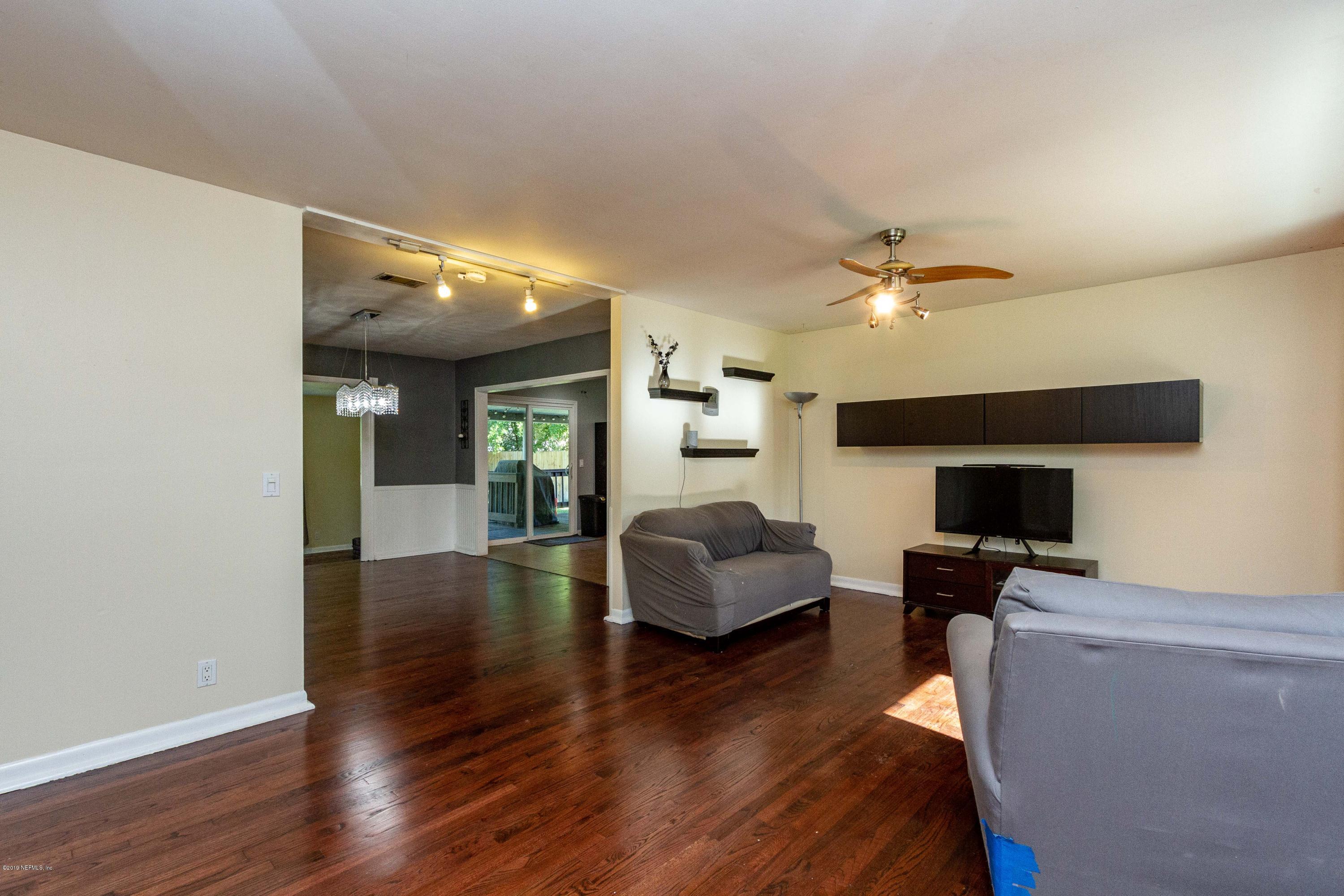 7420 Hennessy Road Jacksonville, FL 32244 - Photo 7 of 39 a living room with furniture and a wooden floor