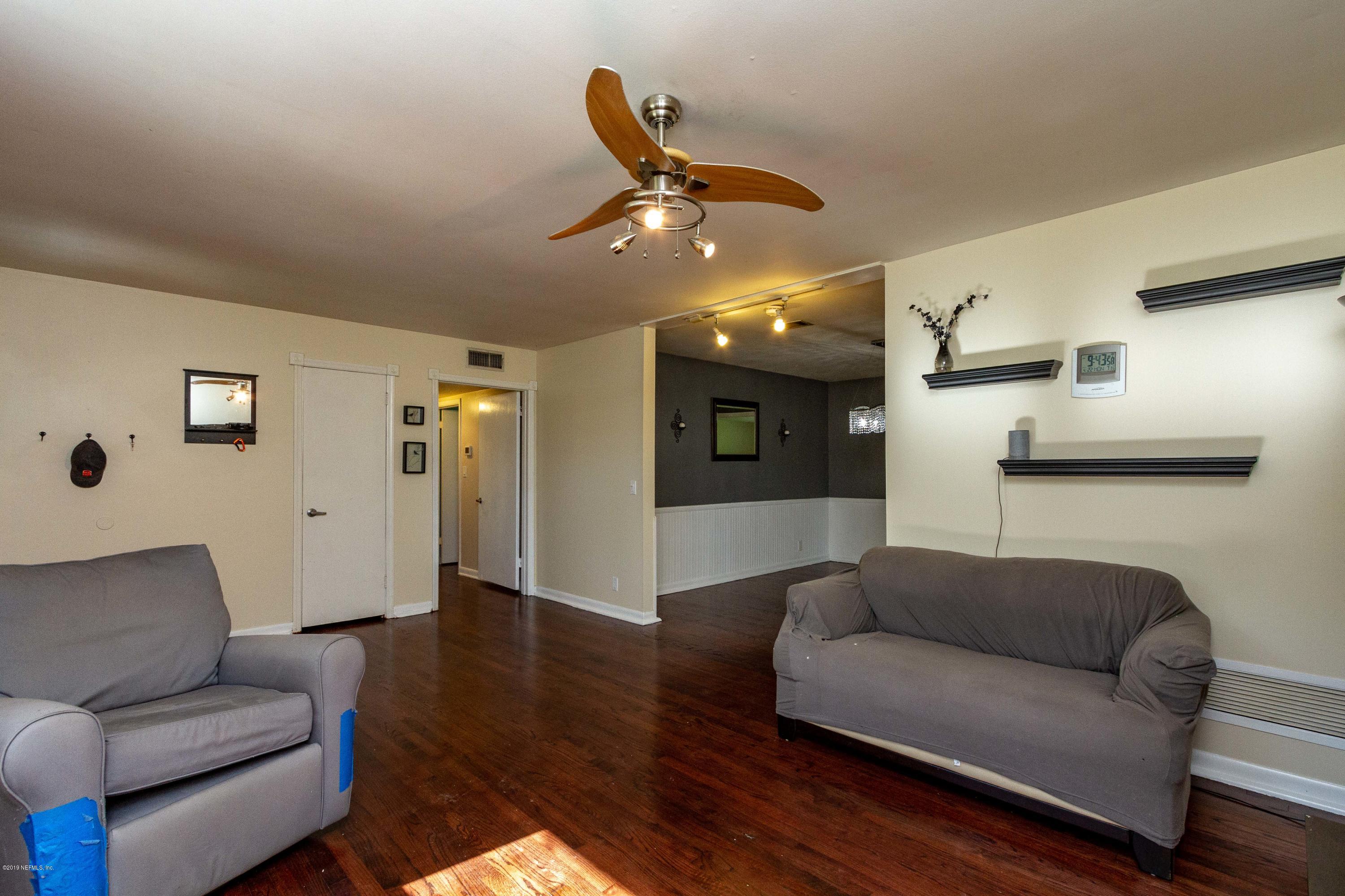 7420 Hennessy Road Jacksonville, FL 32244 - Photo 10 of 39 a living room with furniture and a ceiling fan