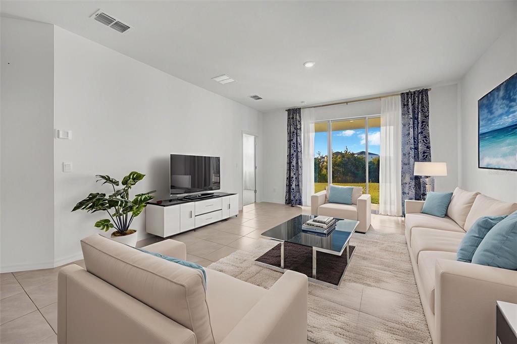 2555 Bending Bonsai Drive Wesley Chapel, FL 33543 - Photo 25 of 59 a living room with furniture and a flat screen tv