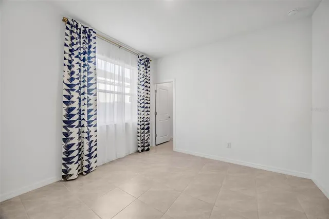 a kitchen with a sink a stove a refrigerator and white cabinets