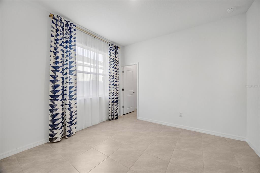 2555 Bending Bonsai Drive Wesley Chapel, FL 33543 - Photo 32 of 59 a view of an empty room with a window