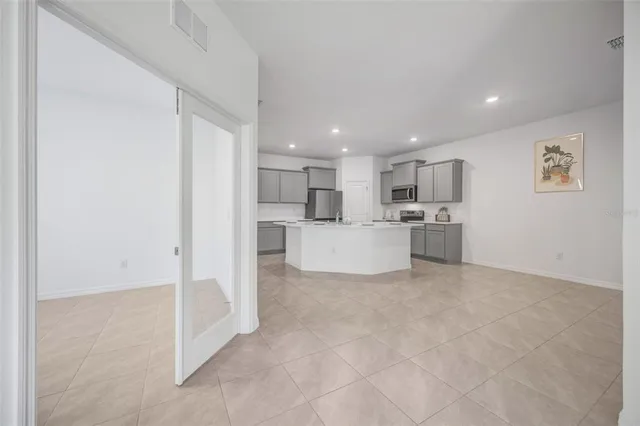 a kitchen with stainless steel appliances granite countertop a sink stove refrigerator and cabinets