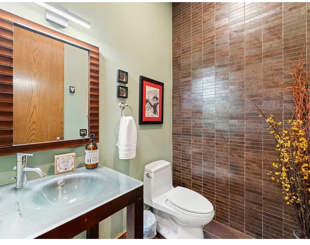 Undisclosed Address Chicago, IL 60608 - Photo 12 of 46 a bathroom with a granite countertop toilet sink and mirror