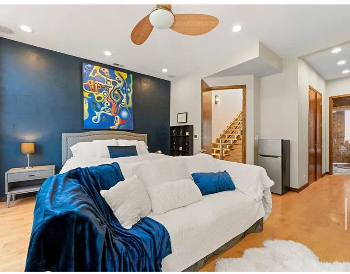 Undisclosed Address Chicago, IL 60608 - Photo 15 of 46 a bedroom with a bed and glass wall