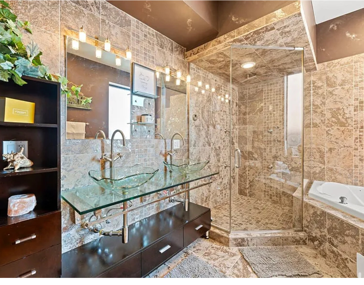 Undisclosed Address Chicago, IL 60608 - Photo 17 of 46 a bathroom with a granite countertop sink a mirror and shower