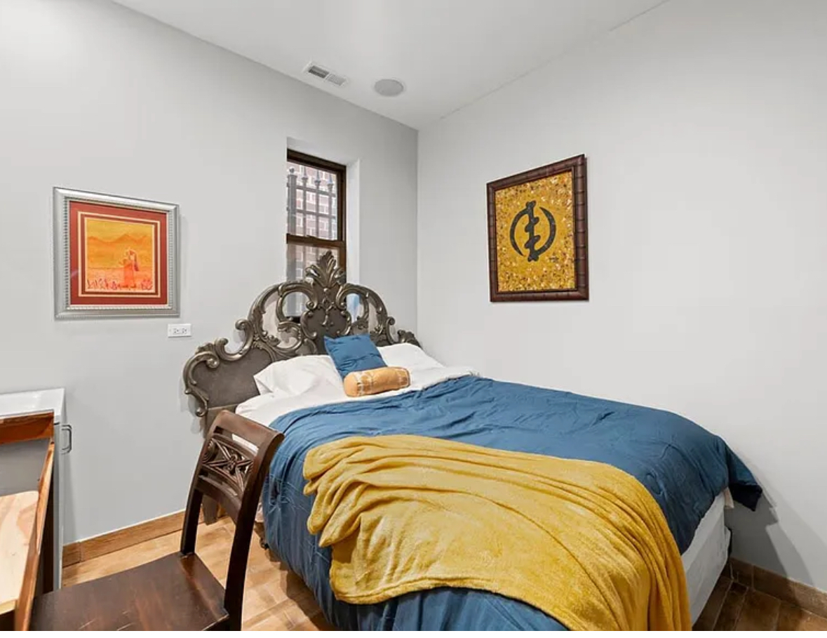 Undisclosed Address Chicago, IL 60608 - Photo 28 of 46 a bedroom with a bed and painting on the wall