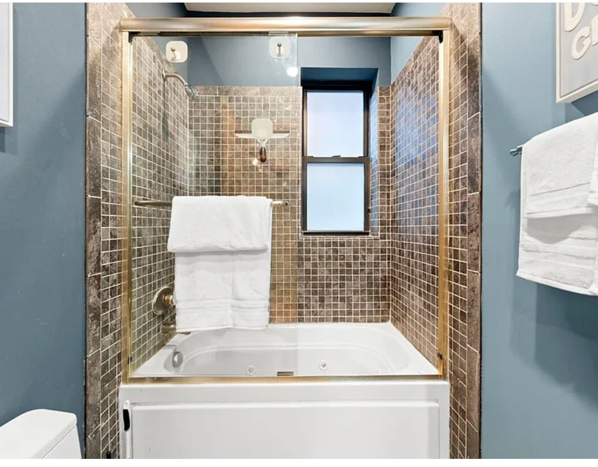 Undisclosed Address Chicago, IL 60608 - Photo 30 of 46 a bathroom with a bathtub and shower