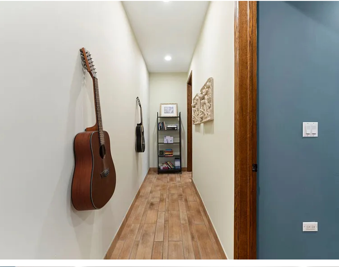 Undisclosed Address Chicago, IL 60608 - Photo 31 of 46 a view of a hallway with wooden floor and stairs
