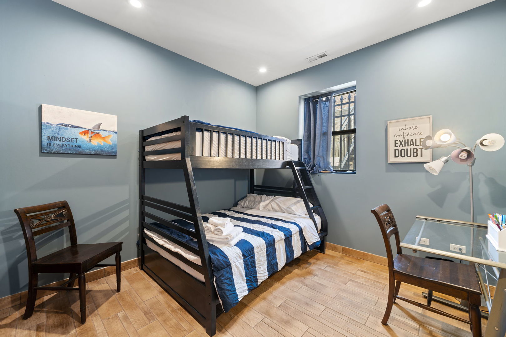 Undisclosed Address Chicago, IL 60608 - Photo 32 of 46 a bedroom with a bed and a bookshelf