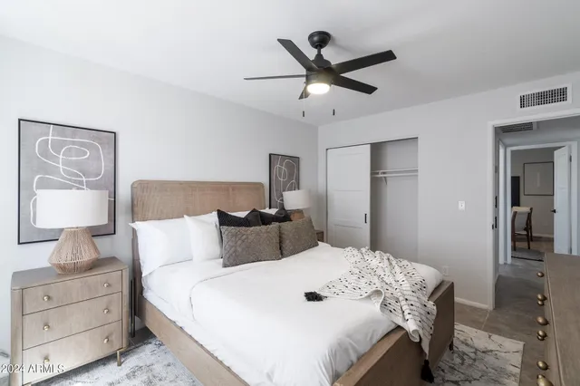 a bedroom with a large bed and a chandelier